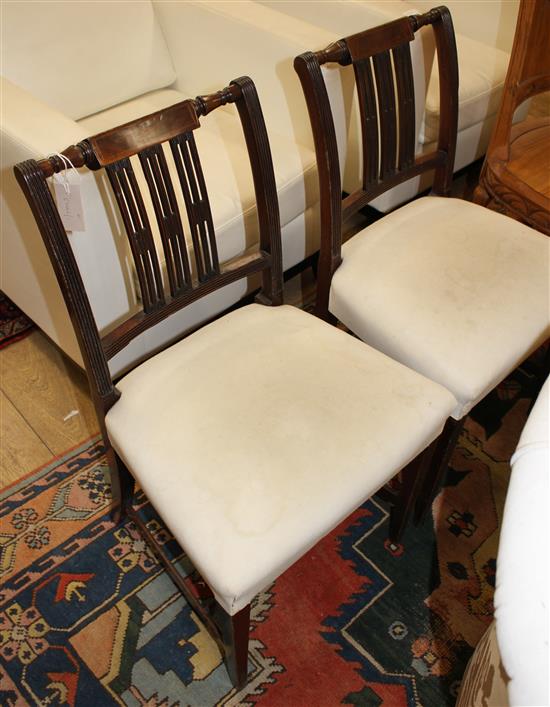 A pair of Lancashire style rush seat dining chairs and a pair of George III style mahogany dining chairs